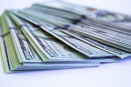 many one hundred dollar bills on a white background.