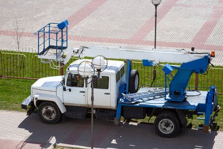 A truck crane from electrical systems on pylons of power lines, folded. Special machine for lifting people.の写真素材