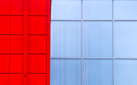 Part of the facade of a red building with windows. Glass modern building concept.の写真素材