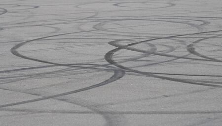 Background asphalt road with car tire skid mark on the track, abstract car drift tire skid mark...