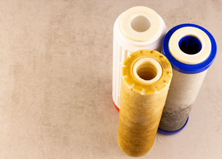 there are three filters on the table after replacing dirty drinking water.copyspace for textの写真素材