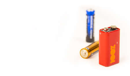 three different colors and sizes of batteries on a white background.copyspace for text.の写真素材