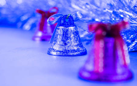 silver christmas bells with bows, tinsel isolated on white backgroundの写真素材