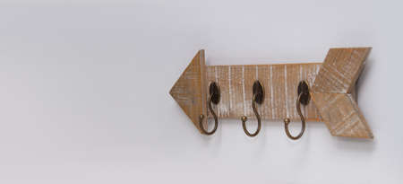 An arrow-shaped hanger for clothes or keys is located on the wall. Retro style