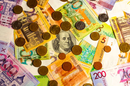 Coins and Paper Money Belarus Lying on a hundred US dollars.