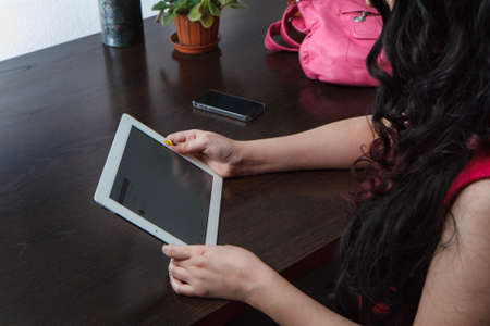 Young girl works on the tablet on the internet, ipad serfingのeditorial素材