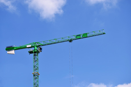 Green crane in the Birmingham city center on the beautiful skyの写真素材