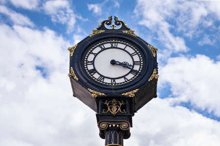 Big clock in the city centre of Stourbridge on sunny day .  Big clock on the blue sky in United...