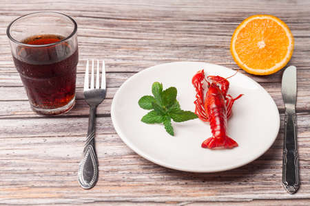 a cooked crayfish in a white plate