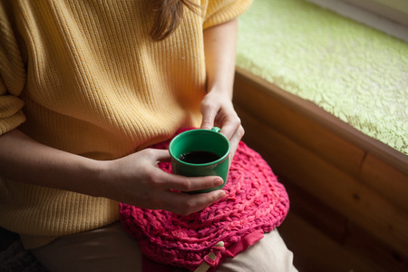 Woman in yellow knitted sweaterの写真素材