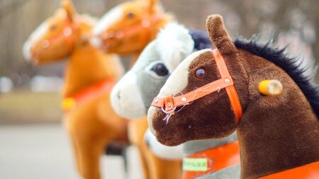 Sideshow of rocking horses in parkの写真素材