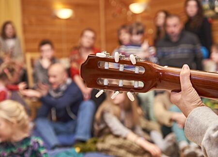 Musician plays for friends on home concertの写真素材
