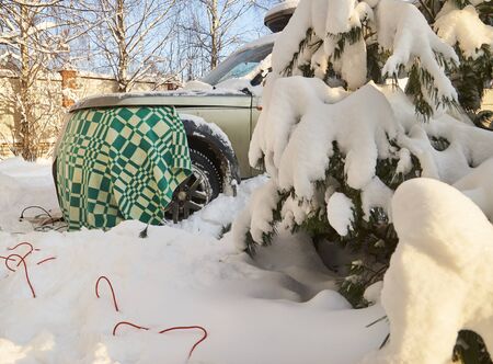 Warming up a diesel engine of suv car  by covering it with a woolen blanketの写真素材