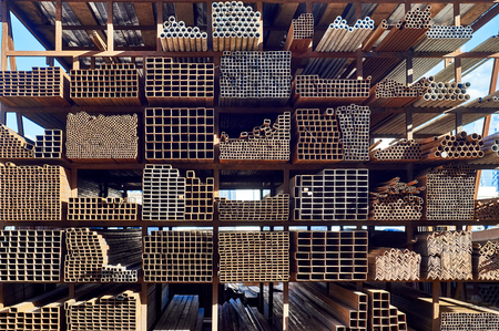 Racks full of rusty steel pipes outdoorsの写真素材