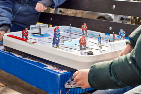 Boys playing board hockey in the parkの写真素材