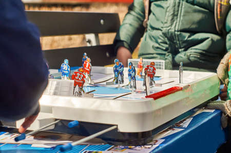Playing board hockey in the parkの写真素材