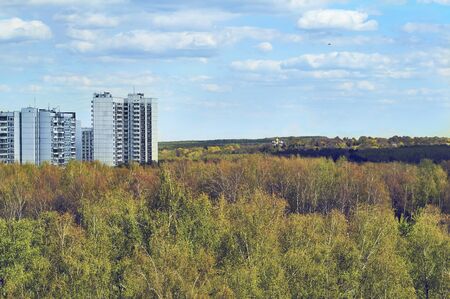 Panel buildings and church in the forestの写真素材