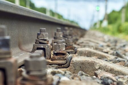 Low angle view of the screws fixing railroad rail close upの写真素材