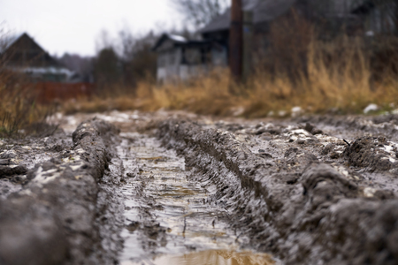 Deep car rut on russian dirt road in winter thawの写真素材