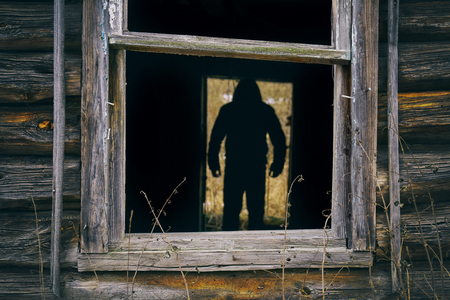 Male silhouette in the doorway of abandoned houseの写真素材