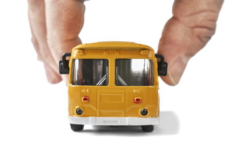 Male fingers holding a small model of old soviet bus close upの写真素材