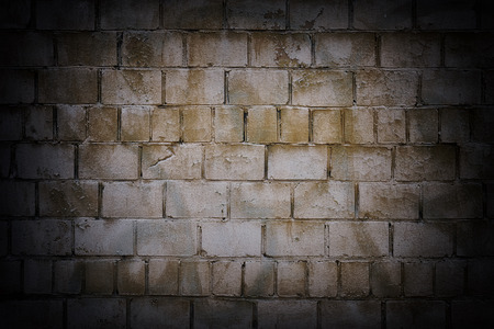 Retro brick shabby wall background with a vignetteの写真素材