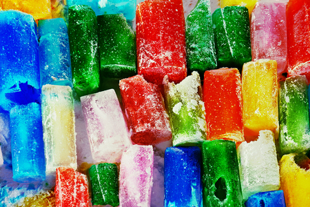 Winter abstract background with a big quantity different colored ice bricksの写真素材