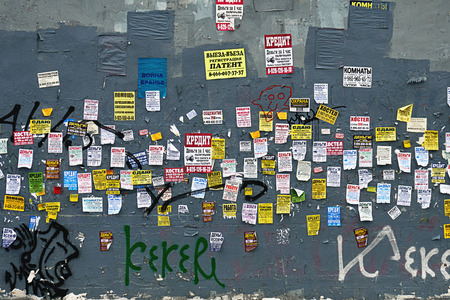 Moscow, Russia - December 08, 2018. Paper advertisements on the shabby wall in Moscow in winter.のeditorial素材