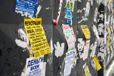 Moscow, Russia - December 08, 2018. Paper advertisements on the shabby wall in Moscowのeditorial素材