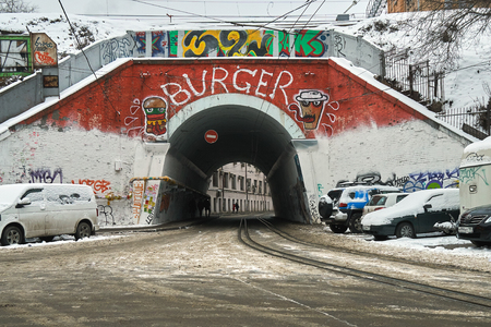 Moscow, Russia - December 08, 2018. Old archway covered with graffiti with tram rails in winterのeditorial素材