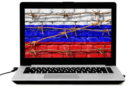 Personal laptop with barbed wires and Russian flag painted on a brick wall on the screen isoalted on the white background. Law of disconnecting Russian Internet from the world wide web comceptの写真素材