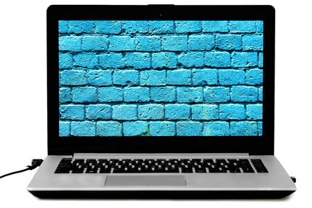Opened laptop with a blue brick wall on the screen. Security, password concept.
