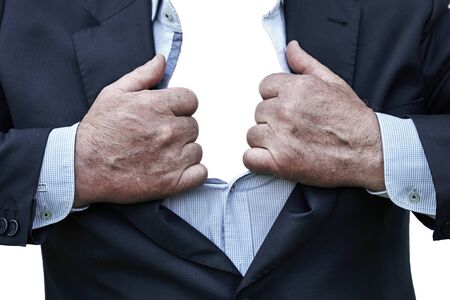 Elderly man tearing a shirt and a suit on his chest isolated on the white background.の写真素材