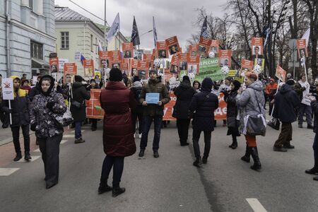 Moscow, Russia - February 29, 2020. People carrying russian flags and banners with photos of Boris Nemtsov and writings: Freedom for our children!のeditorial素材
