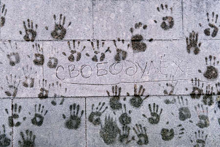 Palm prints of people on a cold snowy frosted wall in defense of illegally arrested Alexei Navalny...