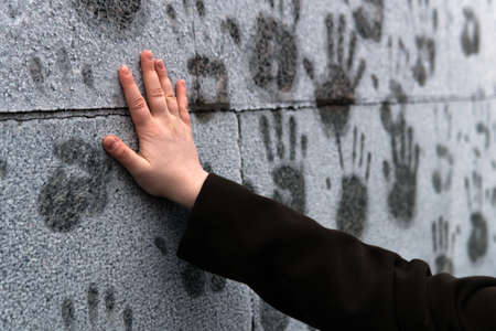 Girl puts her hand to a frosted wall in support of Alexei Navalny during a rally against his arrest...