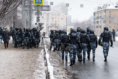 Moscow, RUSSIA - January 31, 2021: Russian riot police officers going along a roadway during an...