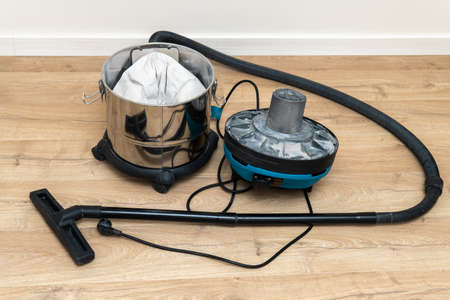 Opened construction vacuum cleaner on the floor