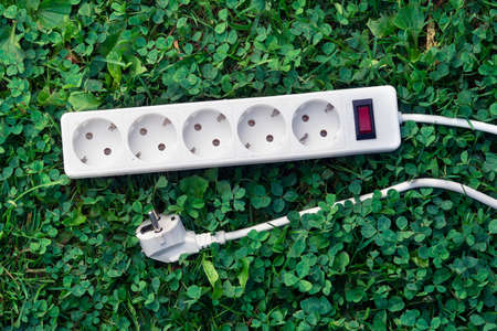 Electric power bar lying on the green grassの写真素材