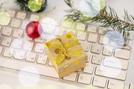 Gift box and Christmas balls on the computer keyboardの写真素材