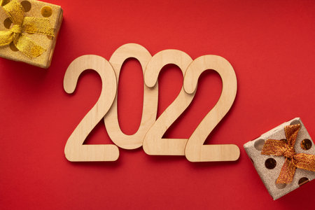 2022 plywood new year numbers on the red paper with gift boxes
