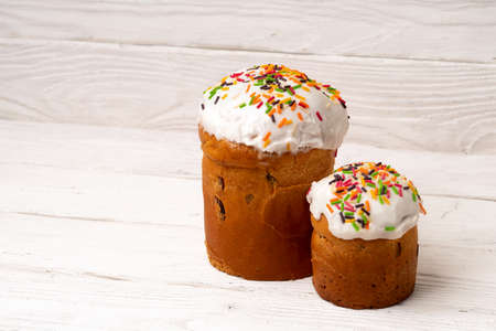 Traditional Easter russian orthodox cakes kuliches on white wooden boards