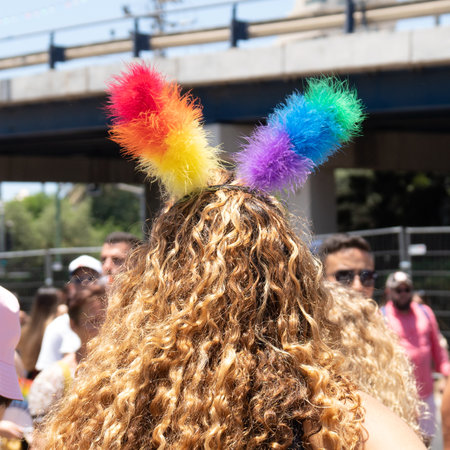 Behind shot of a girls head with decorative horns of lgbt rainbow colorsの写真素材