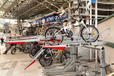 Tel Aviv Yafo, Israel - October 26,2022. Bicycles stand on a double-decker bike parking near an railway station in Tel Avivのeditorial素材