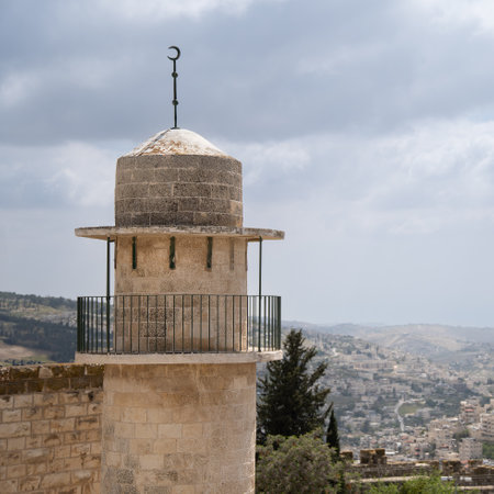 Mosque minaret close-up with Jerusalem houses in the backgroundの写真素材