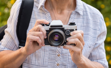Retro film photo camera in female hands