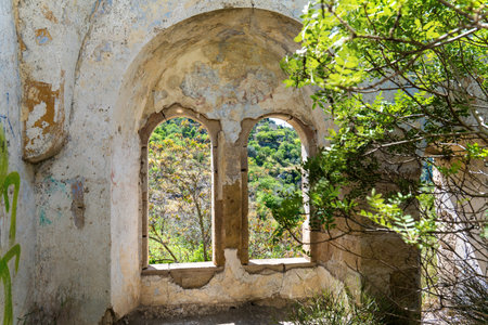 Ruined Stone Window Overlooking Lush Green Landscapeの写真素材