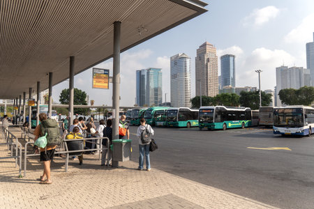 Tel Aviv, Israel-October 4,2025. Crowded urban bus terminal with city skylineのeditorial素材
