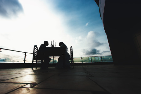 Couple Silhouettes on Balconyの写真素材