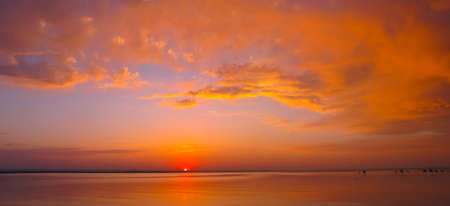 Panorama, summer beautiful dramatic red sunset at the sea        の写真素材